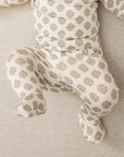 Baby outfit with floral pattern on a neutral background