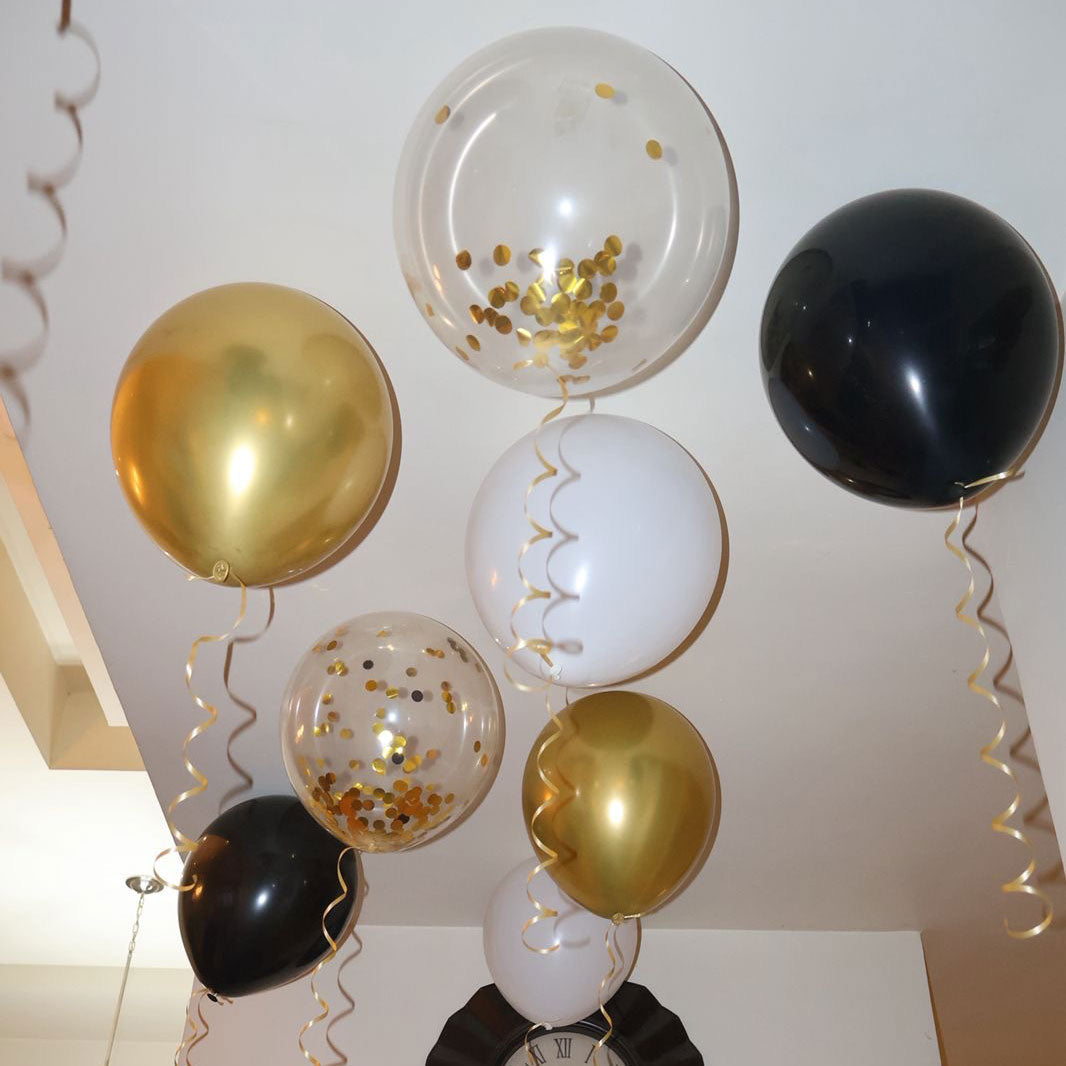 New Years decorations and gold, white, and black helium balloons in a home