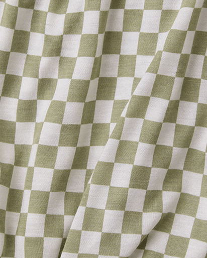 A close-up of a fabric with a sage green and white checkerboard pattern, showing soft folds and a textured weave.