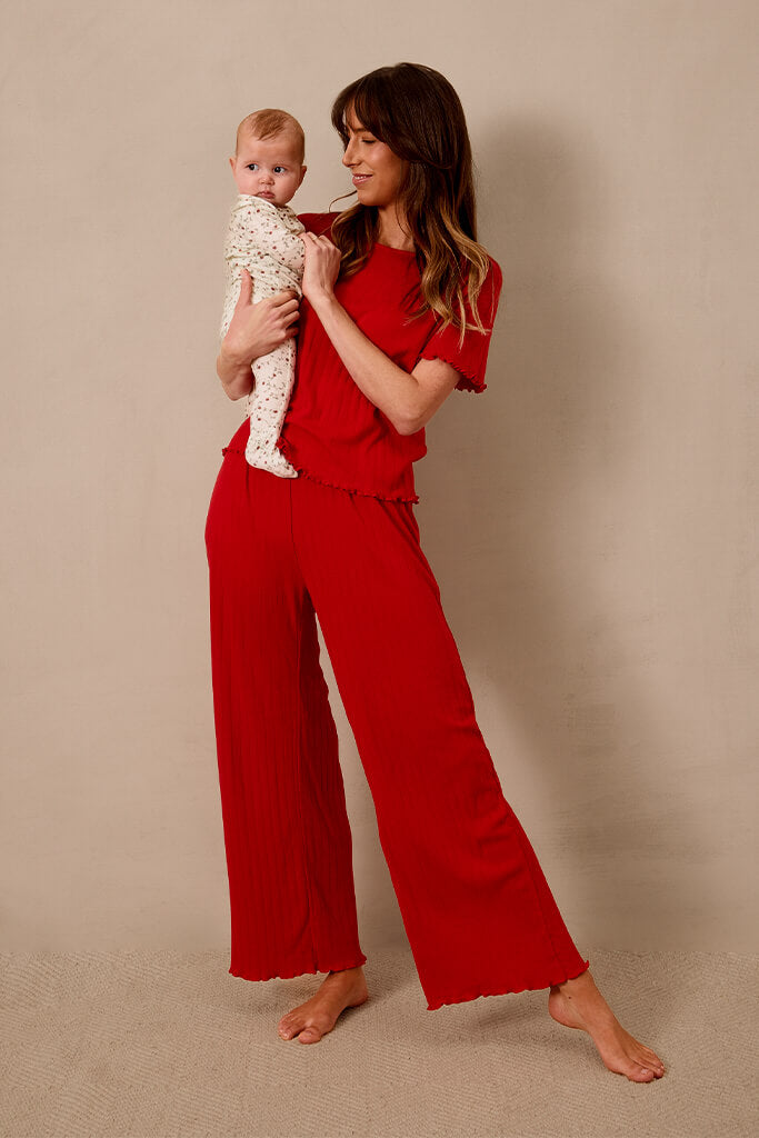 Image of mom wearing the Solly Baby Red Pointelle Sleep Set.