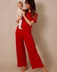 Image of mom wearing the Solly Baby Red Pointelle Sleep Set.