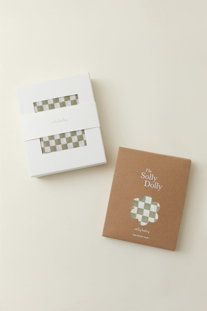 Two packages of green and white checkered cloth, one in white box and one in brown box labeled "The Solly Dolly