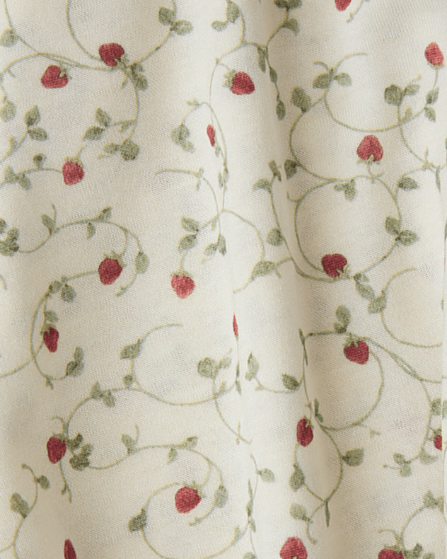 Close-up of fabric with strawberry pattern on a white background