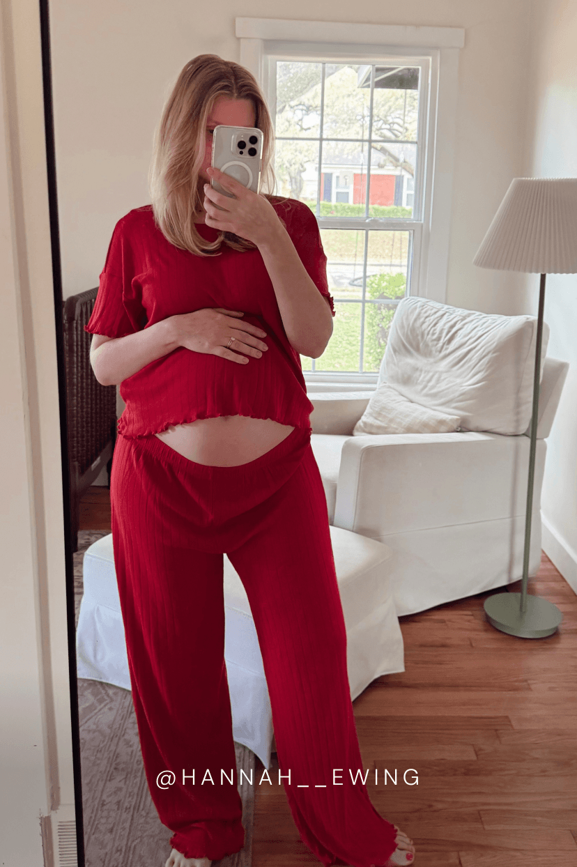 Person wearing a red pointelle outfit taking a mirror selfie in a living room. @hannah__Ewing