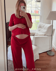 Person wearing a red pointelle outfit taking a mirror selfie in a living room. @hannah__Ewing