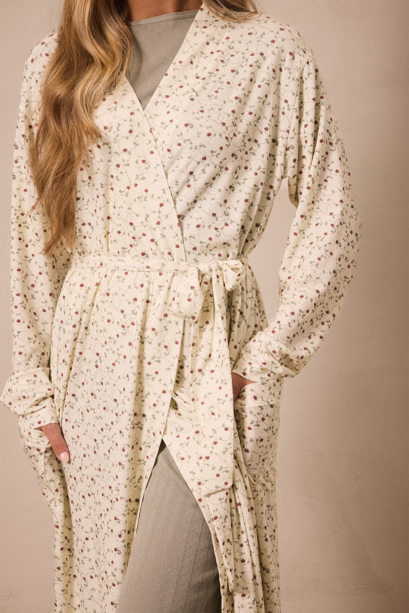 strawberry patterned robe worn by a person on a beige background