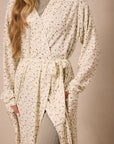 strawberry patterned robe worn by a person on a beige background