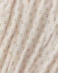Cream fabric with small pink floral pattern and green stems, soft and lightweight material.