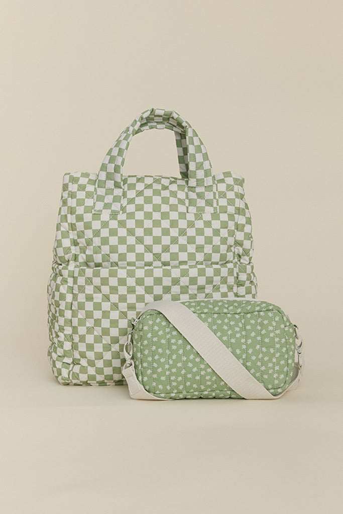 Green and white checkered tote bag with padded handles and small green floral crossbody bag with white strap.