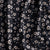 Navy blue fabric with small white ikat floral pattern