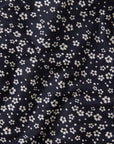 Navy blue fabric with small white ikat floral pattern
