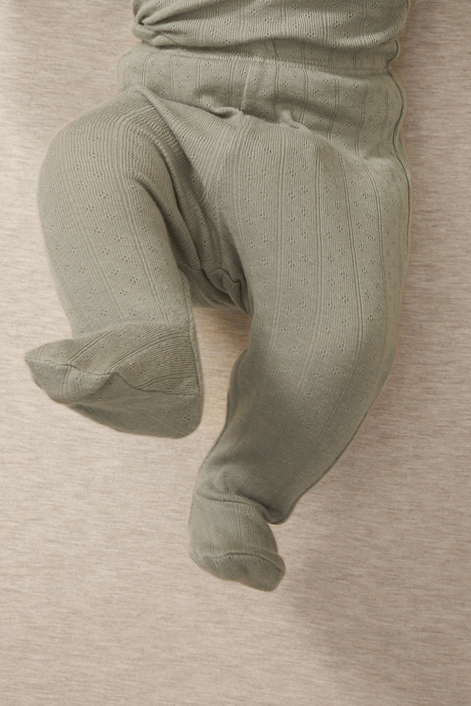 close up of a baby wearing mist pointelle pajama pants