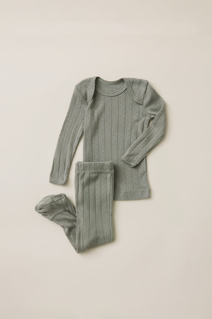 Set of mist pointelle ribbed pajamas on a beige background