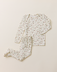 The Baby Sleep Set in a dainty, strawberry vine print, featuring a long-sleeve top and matching footed leggings laid flat on a neutral background.